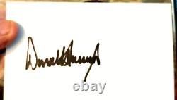 Trump The Art Of The Deal with a signed index card